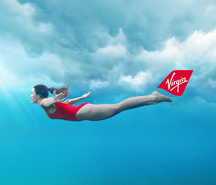 Lady swimming with the Virgin tailfin behind her