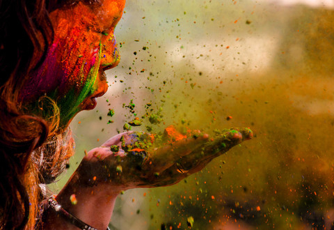 Person blowing colourful confetti