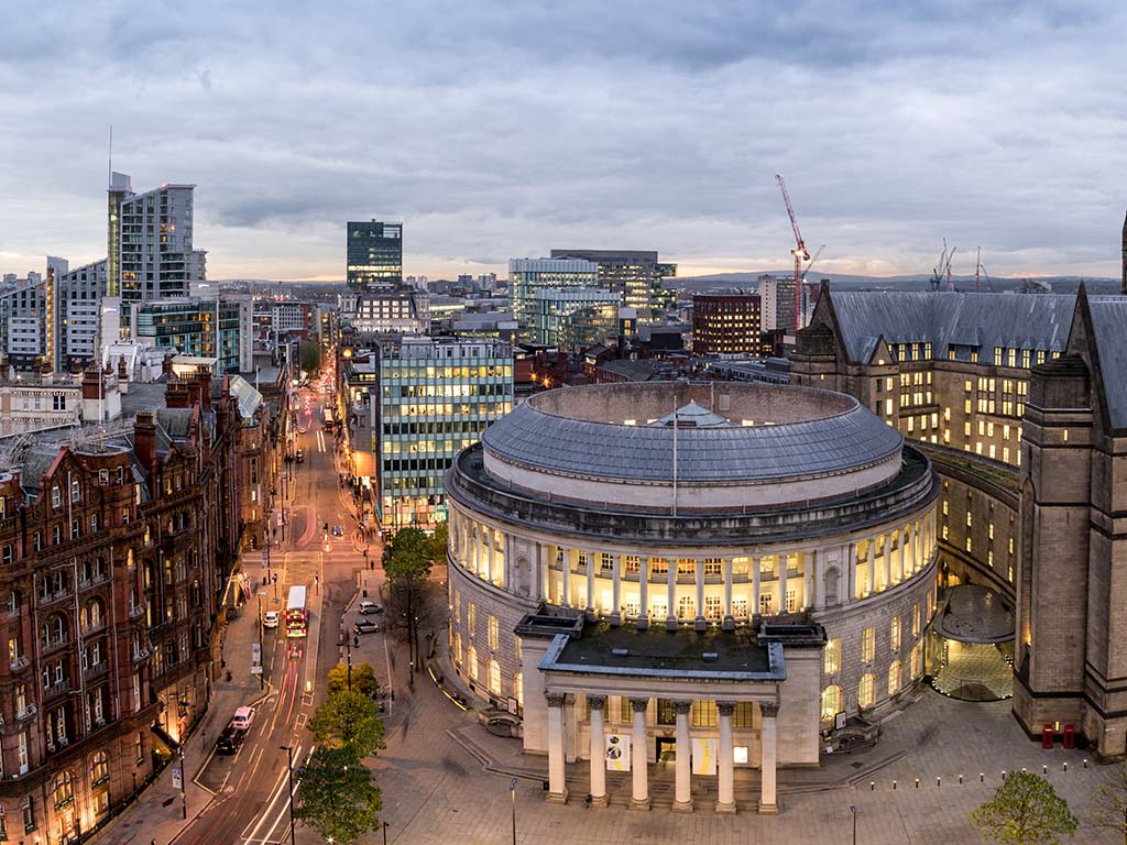 St Peters Square in Manchester seen from above at dusk, with city lights behind