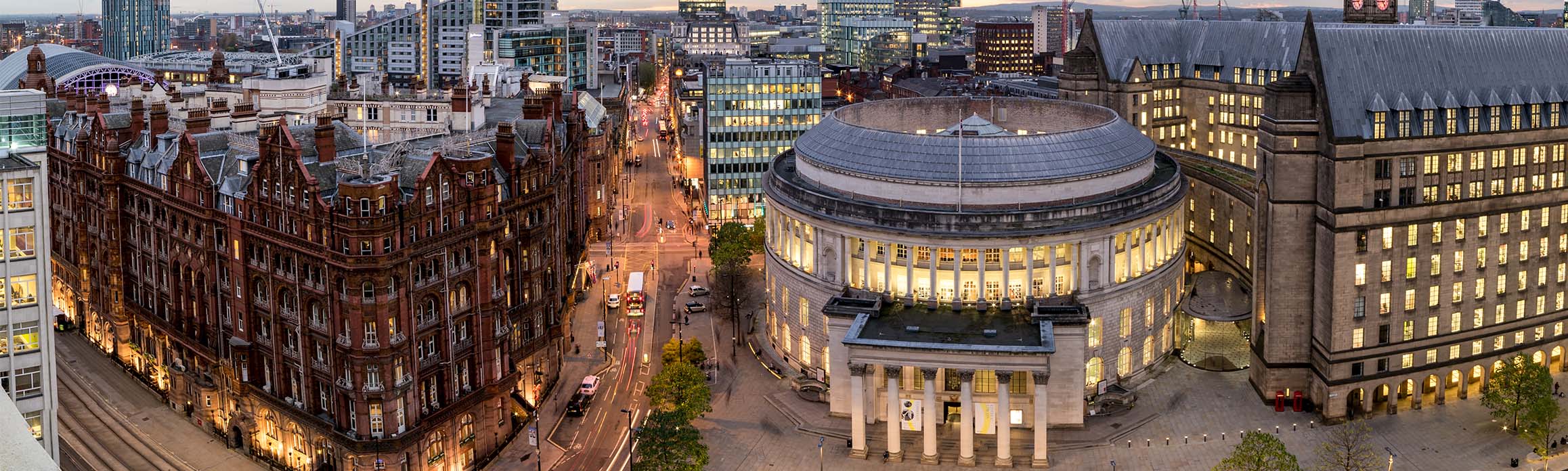 St Peters Square in Manchester seen from above at dusk, with city lights behind