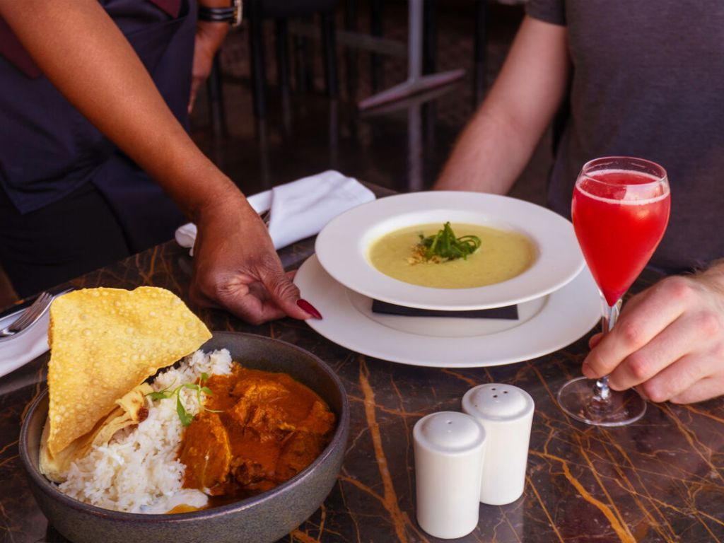Upper Class meal in lounge with soup, curry and cocktail