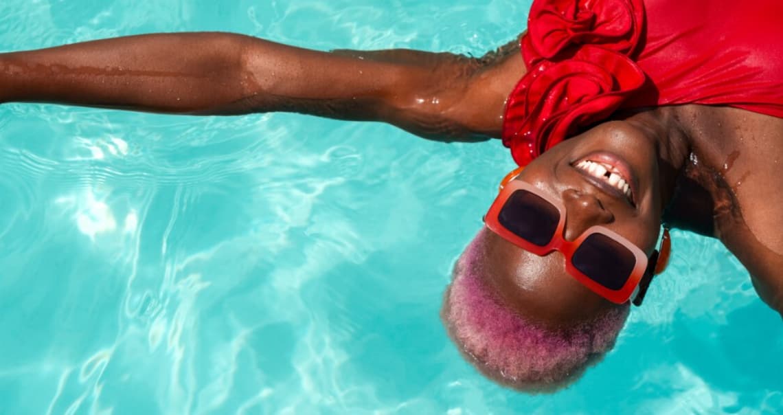 Lady in red swimsuit floating in the pool