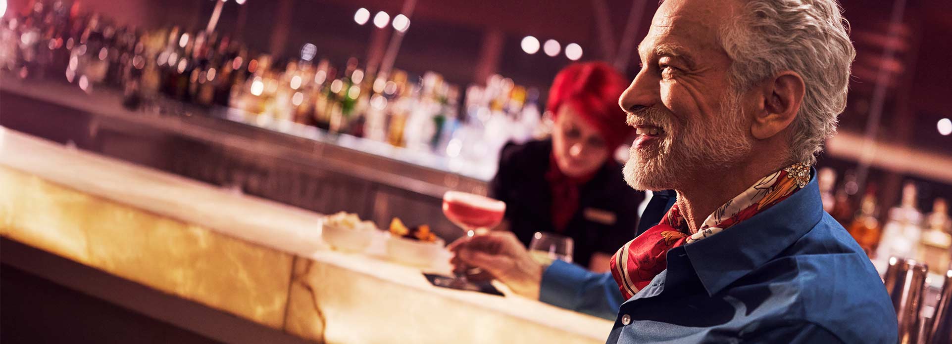 Man having a drink at the Clubhouse at Heathrow