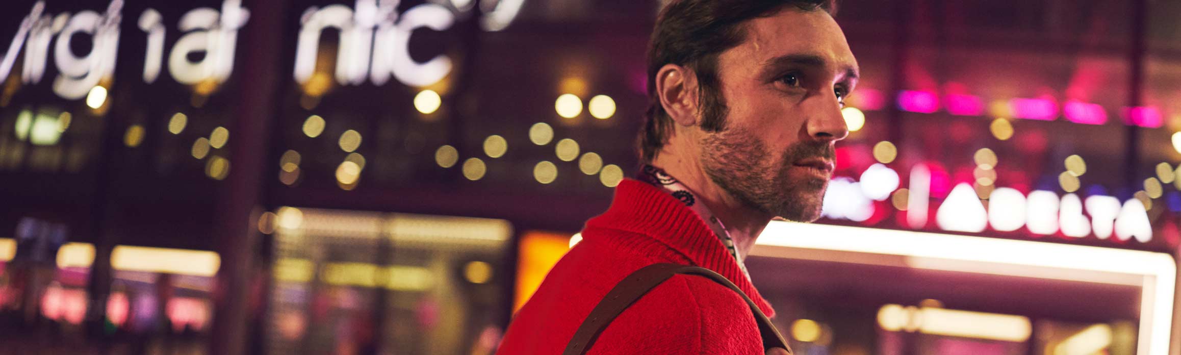 Man in a red jumper walking into Terminal 3 at Heathrow