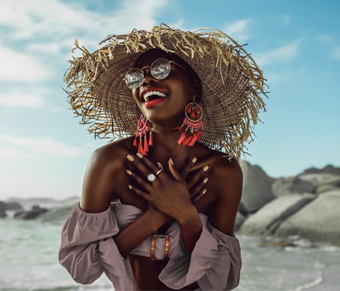Lady in straw hat on the beach