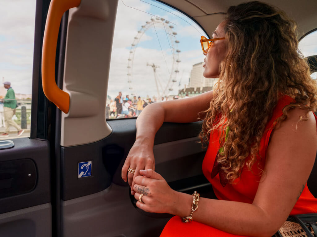 Man looks out of the window of taxi whilst driving past Big Ben