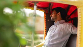 Man on a tuk tuk in India