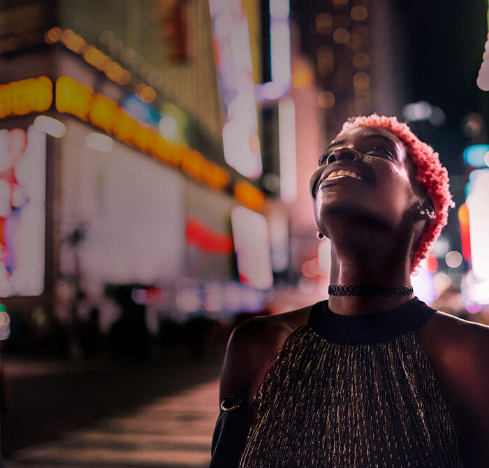 Woman looks up at the lights in Times Square