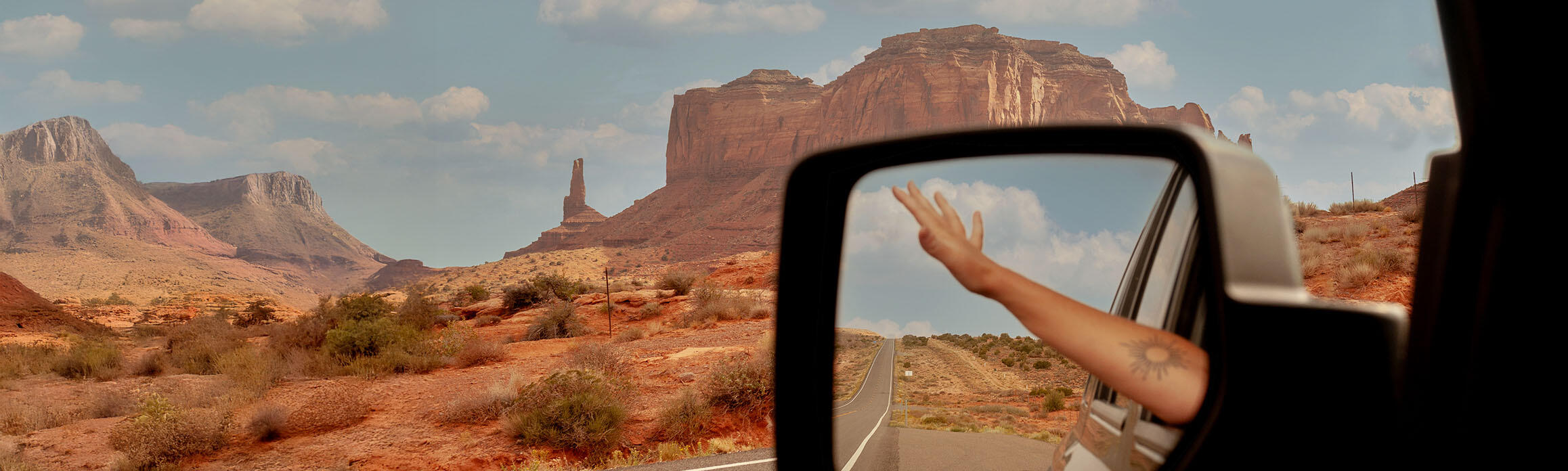 Reflection of moutain views in a car wingmirror 