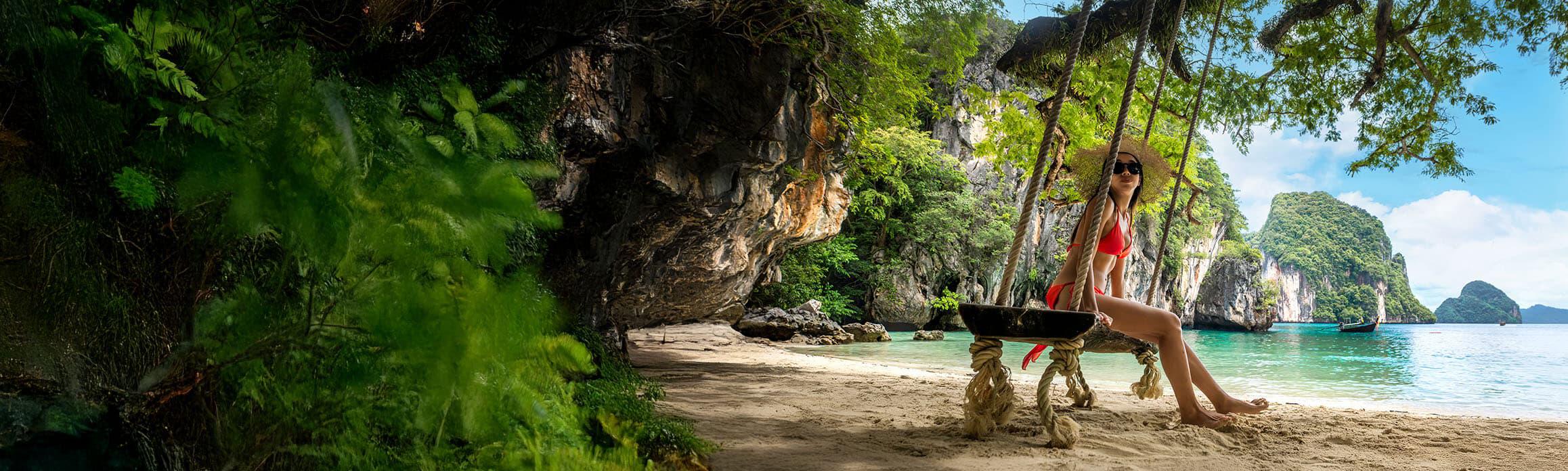 Lady on a swing on the beach in Thailand