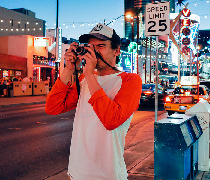 Man taking a photo in the street in Vegas