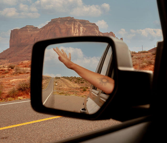 Reflection of moutain views in a car wingmirror 