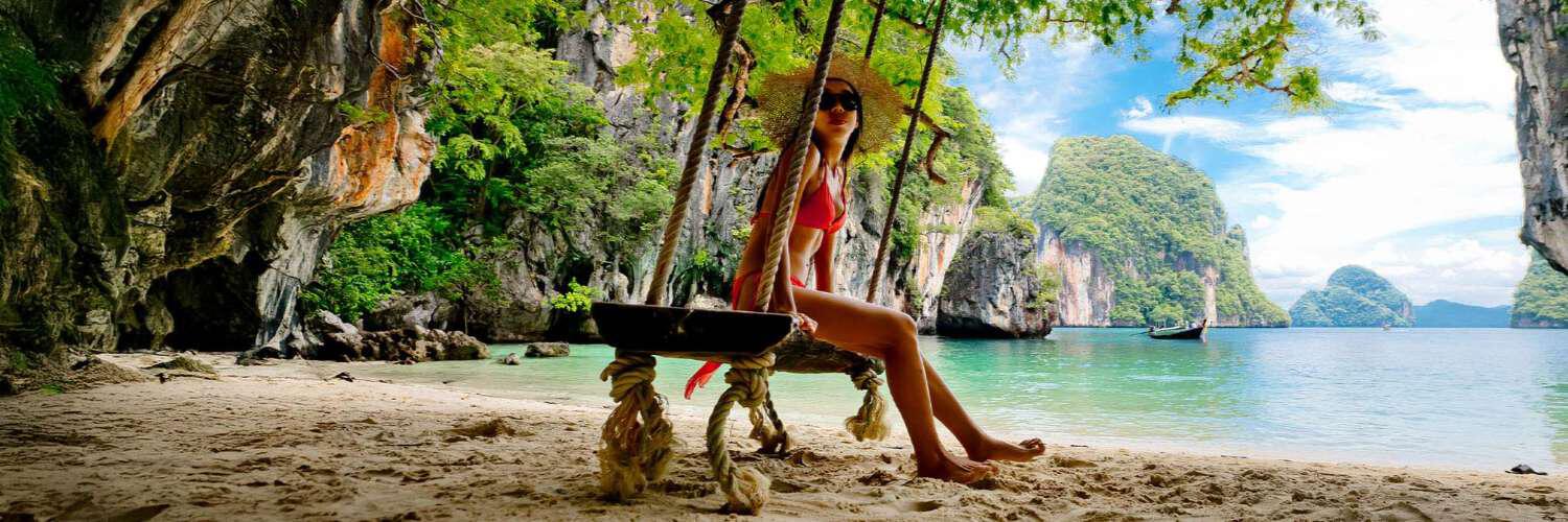 Lady on a beach swing in Thailand