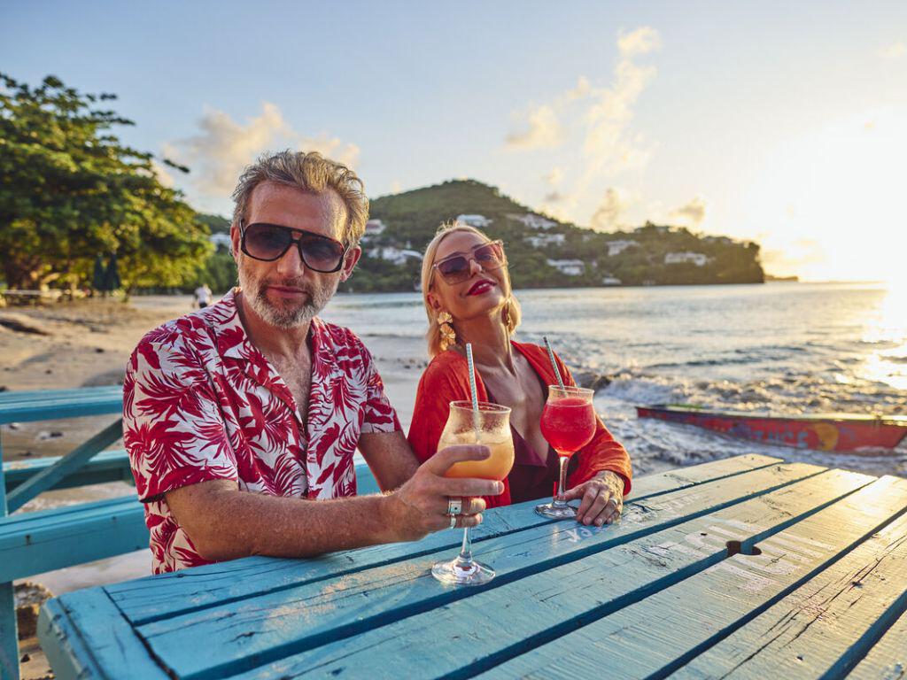 Couple having drinks on the beach