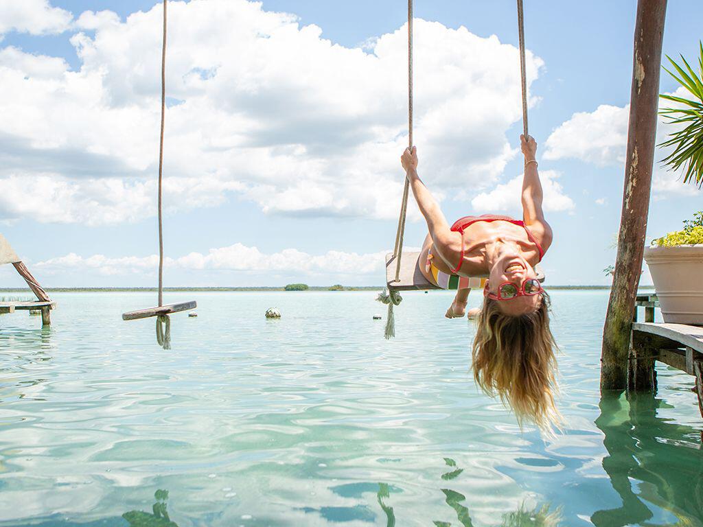 Woman on a swing in the sea