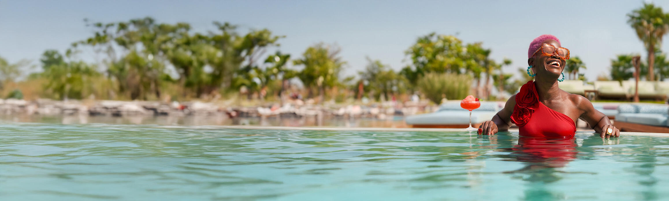 Lady with cocktail in pool