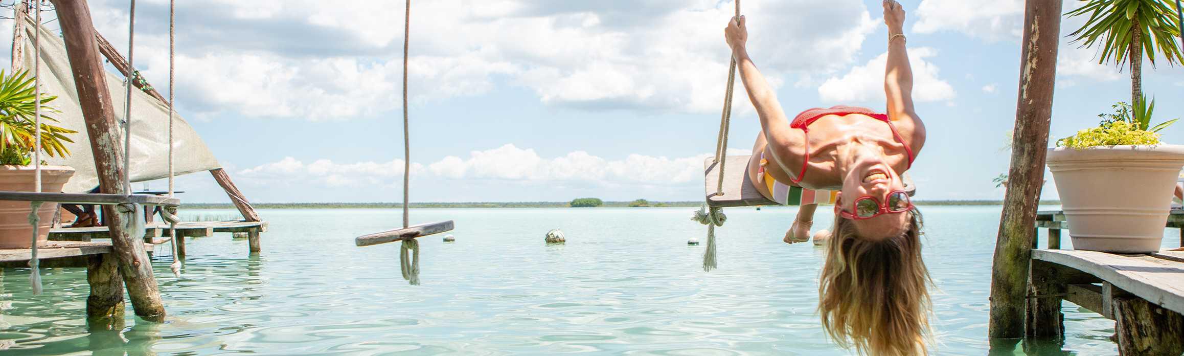 Woman on a swing on the beach