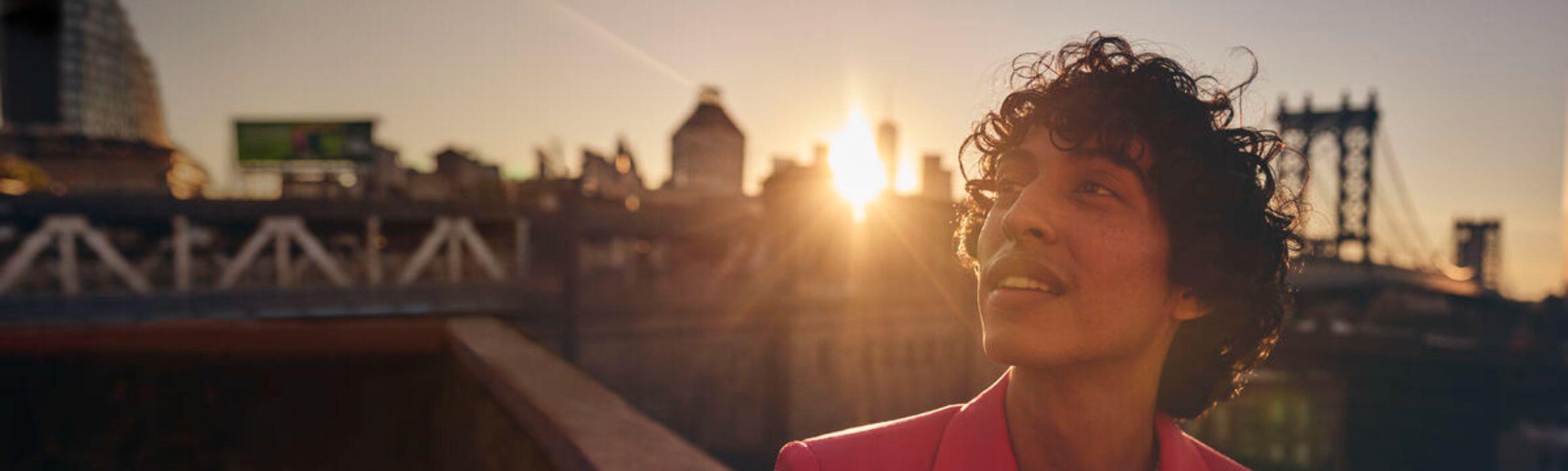 Man by Brooklyn Bridge at sunset
