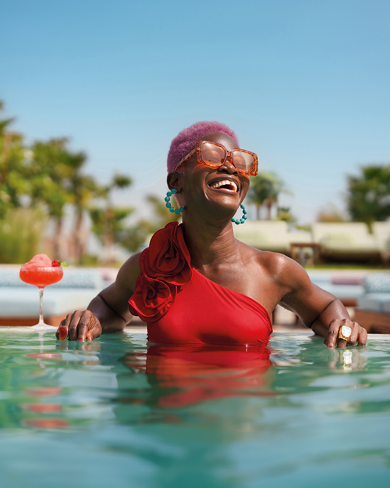 Lady with cocktail in pool