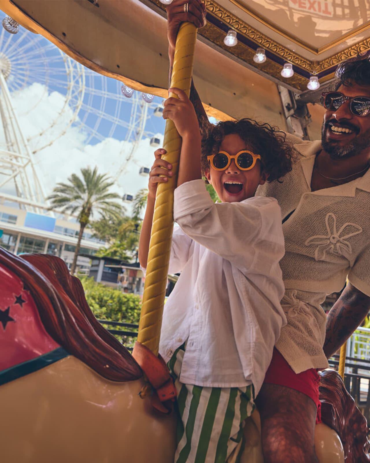 Man and boy on carousel in Orlando