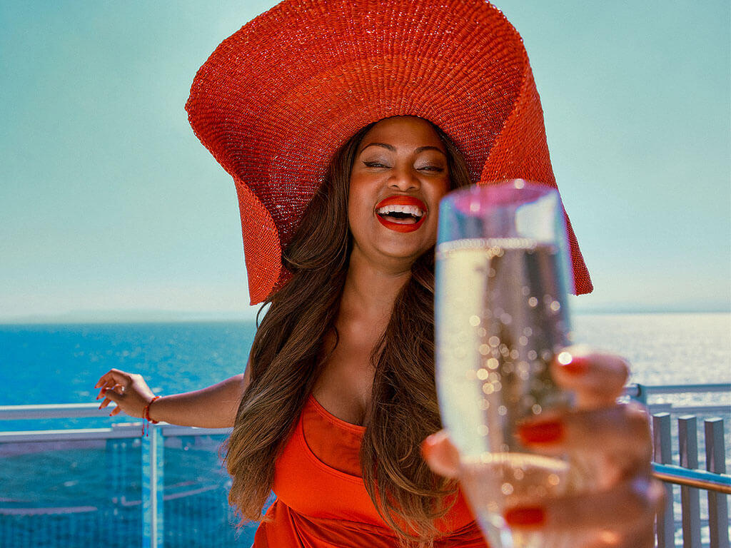 Lady on a cruise with a glass of champagne