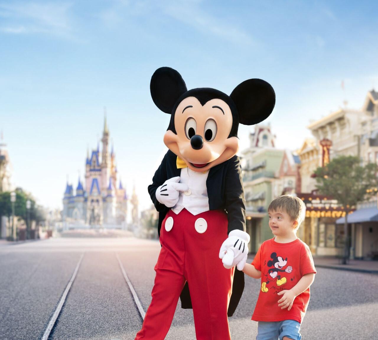 Boy with mickey in front of the castle