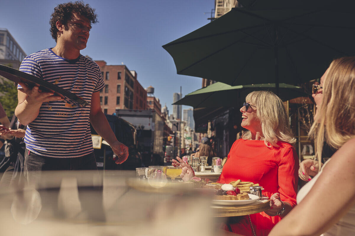Lady eating pizza in New York