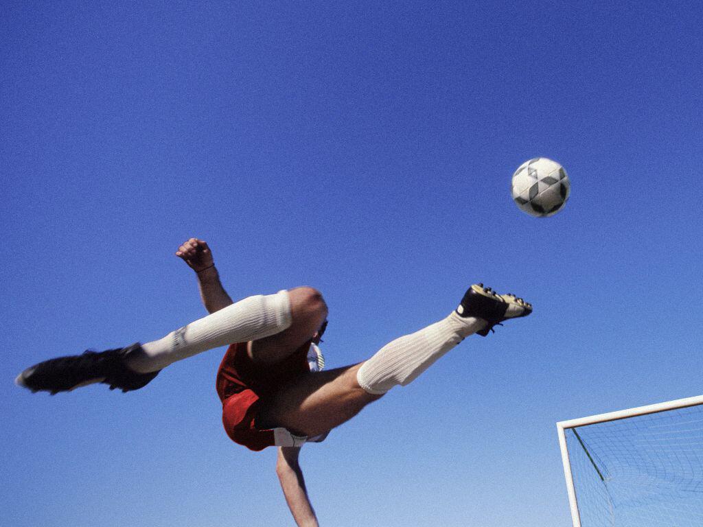 Footballer kicking the ball