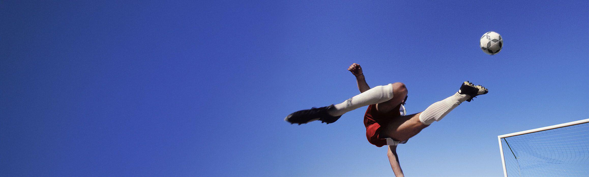 Footballer kicking the ball