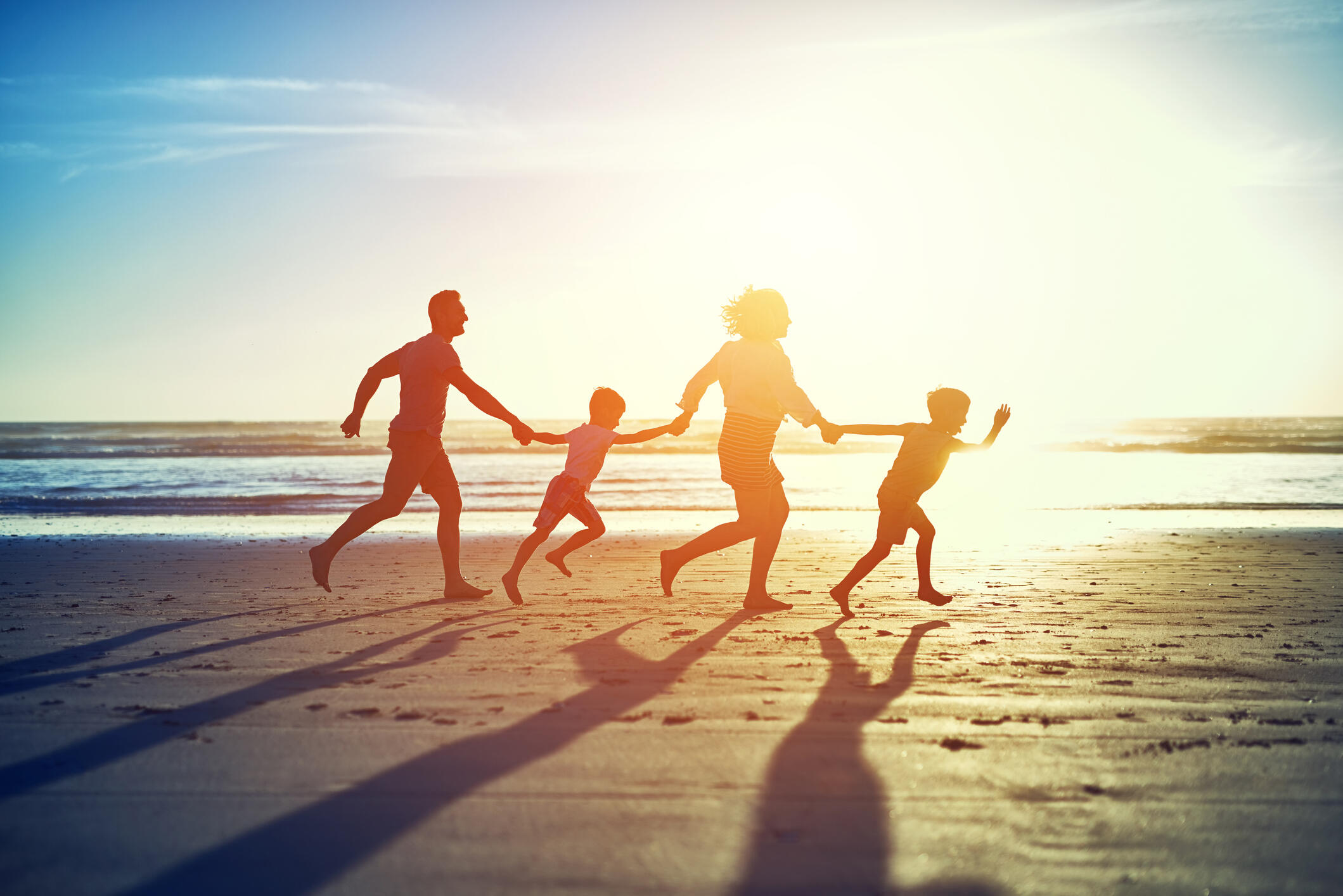 Family running on the beach