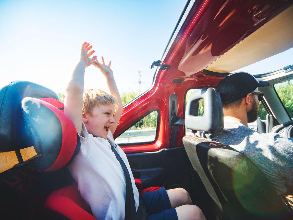 Father and son in car on holiday