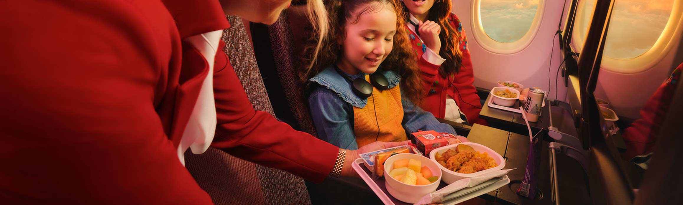 Child in economy being served a meal