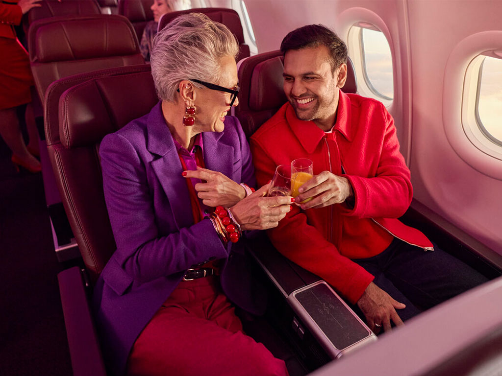 Couple in Premium seats having a drink together