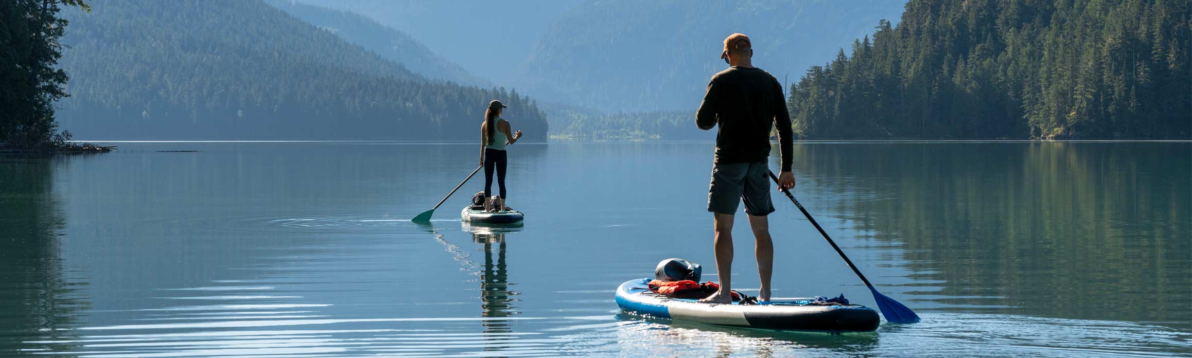 Stand up paddleboarders on lake in Canada