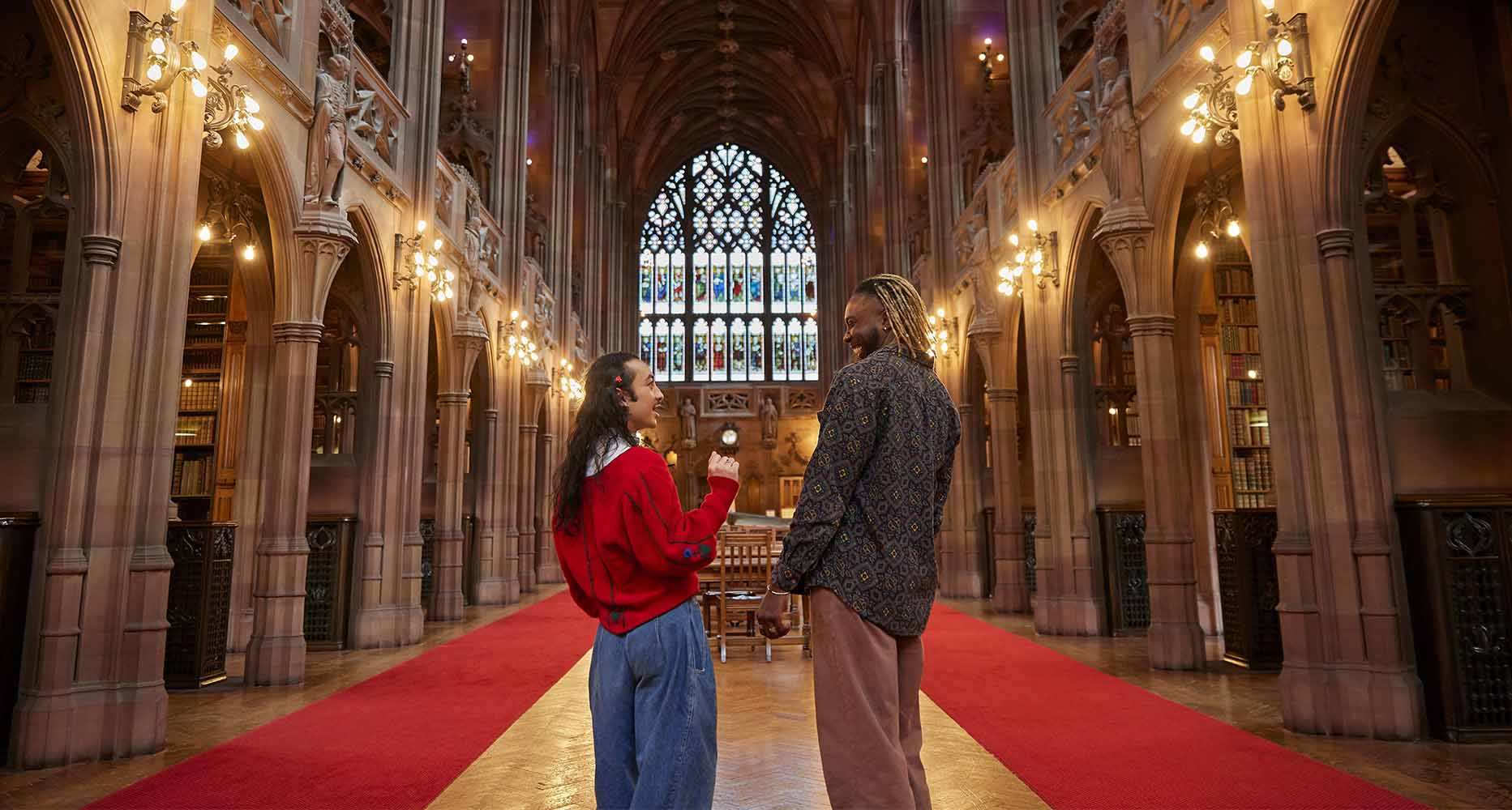 Two people talk in John Rylands library in Manchester