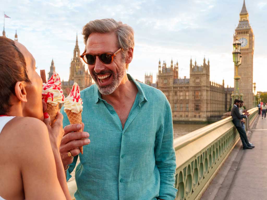 Couple eating ice cream on Westminster Bridge in London