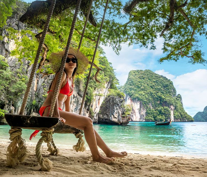 Lady on a swing on the beach