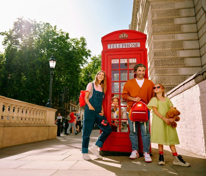Family by a London phonebox in the sunshine