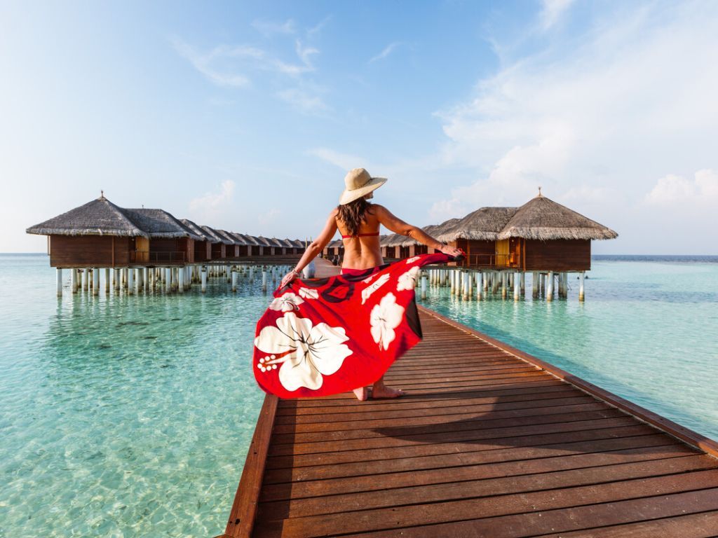 Lady in the Maldives walking down getty to over water villas