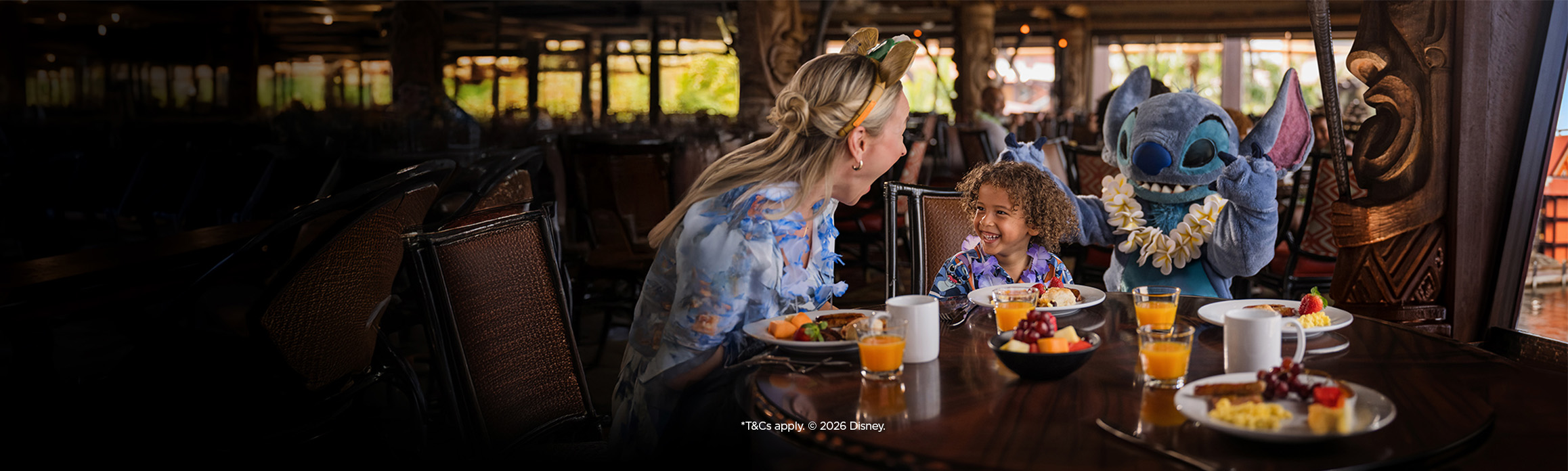Mum and child having character breakfast with Lilo and Stitch