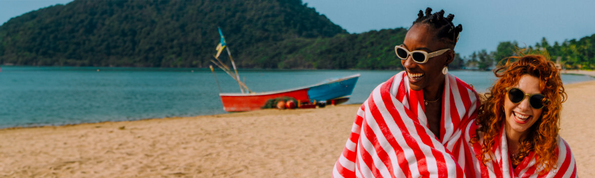 Couple on the beach in stripey towel